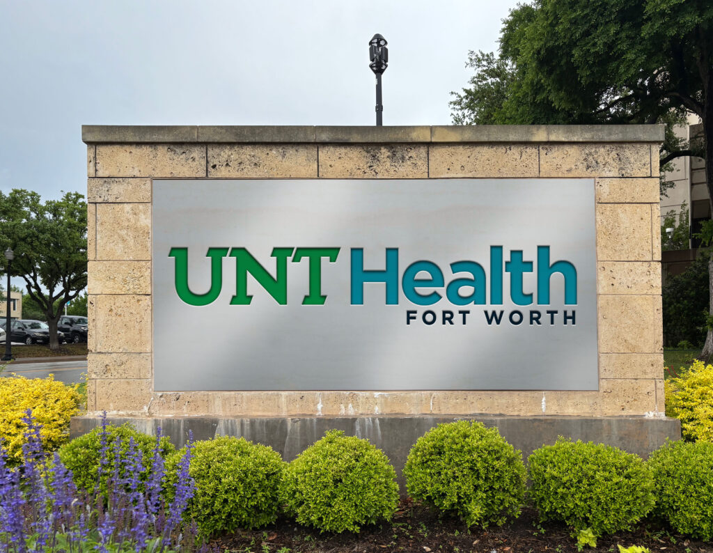 Artist representation of how the new UNT Health Fort Worth logo would look in full color on a campus sign