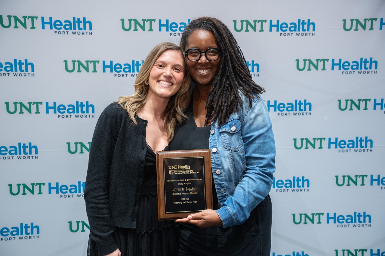 Employee and student at award ceremony