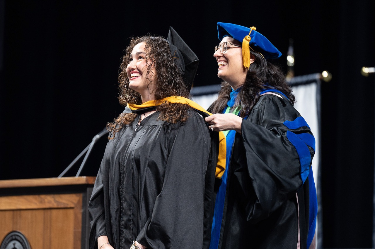 CBTS Faculty member and student at commencement