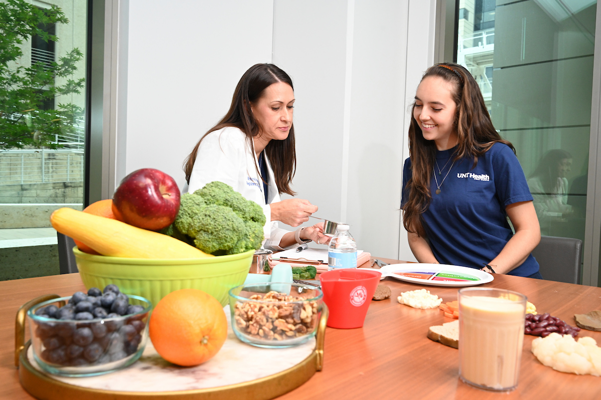 A nutritionist counseling a patient