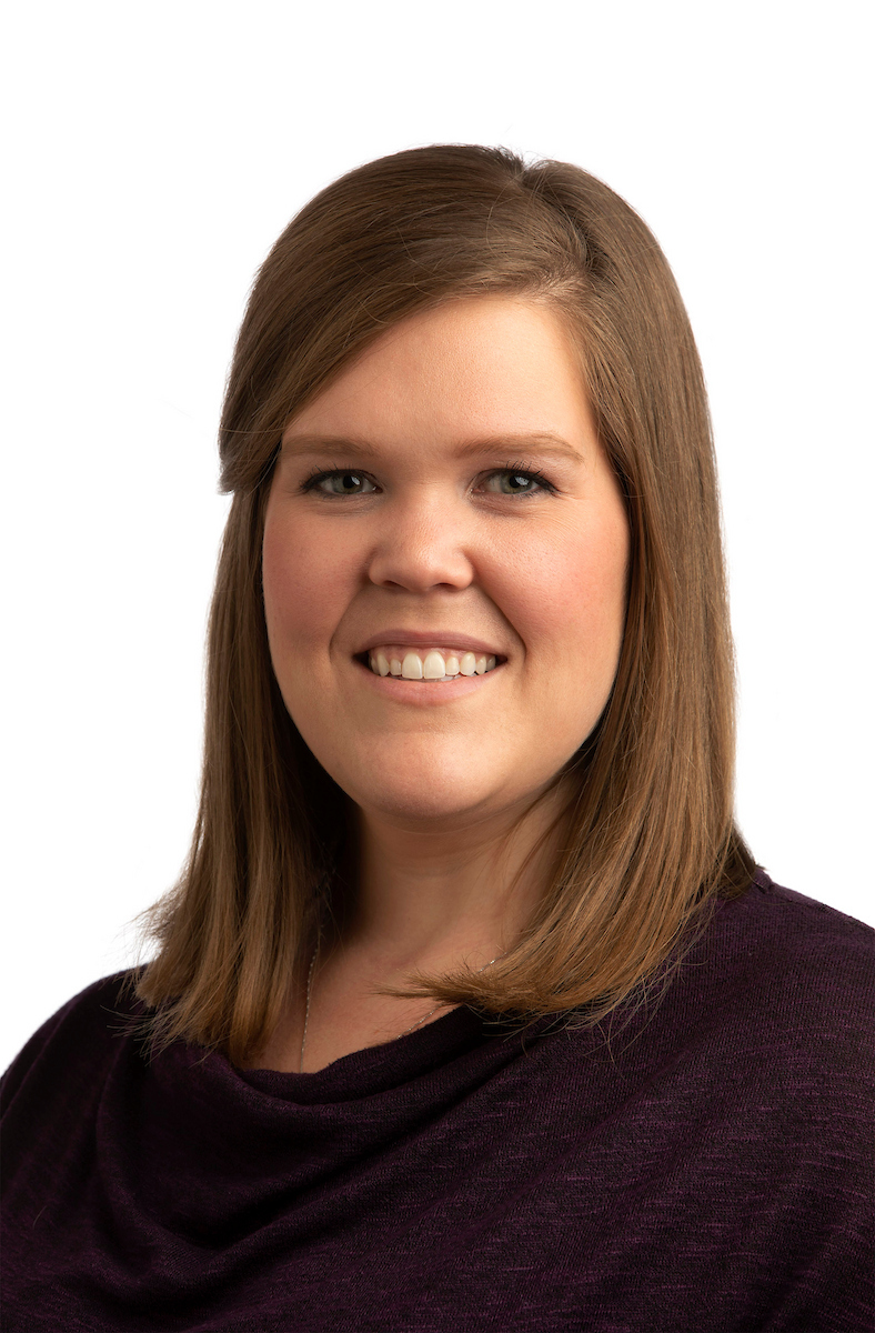 Jennifer Crumm headshot wearing a dark purple shirt