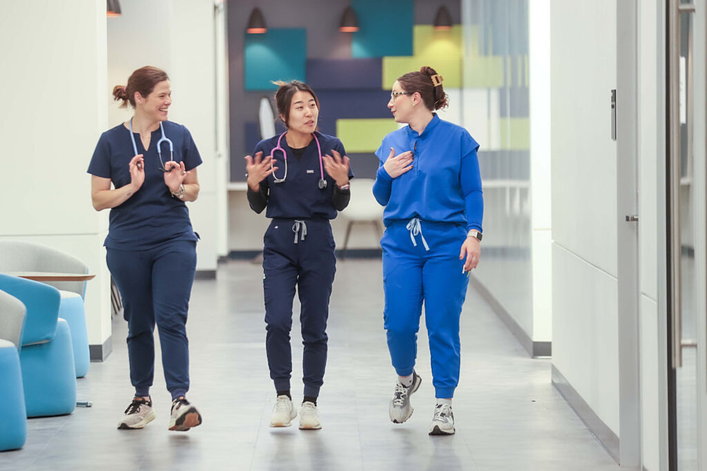3 nursing students walking down the hallway