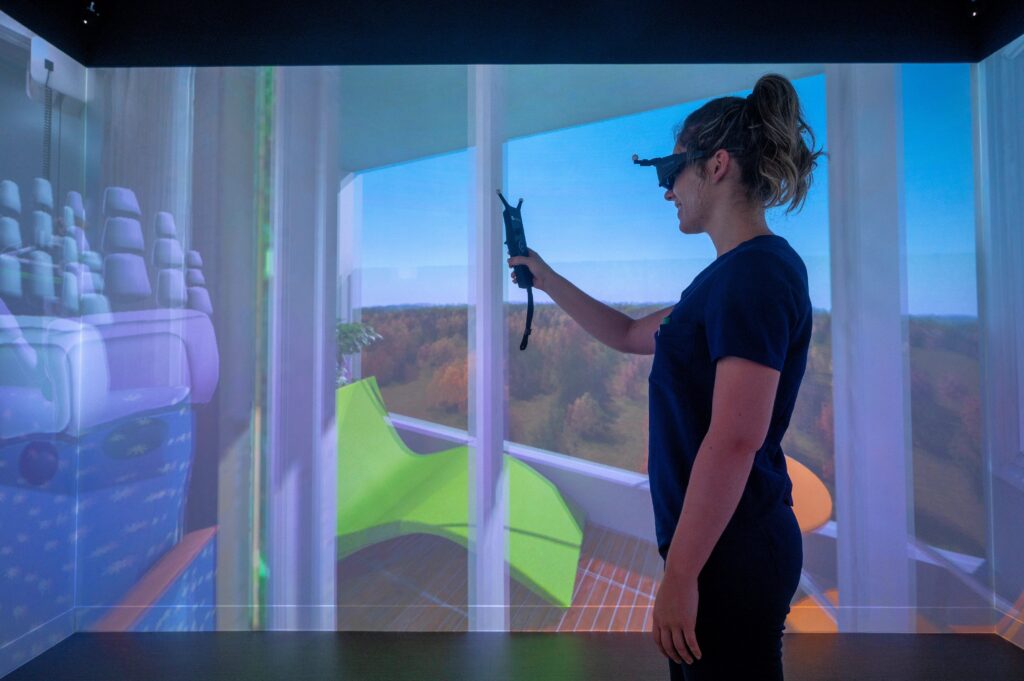 a student with virtual reality goggles on in the sim lab