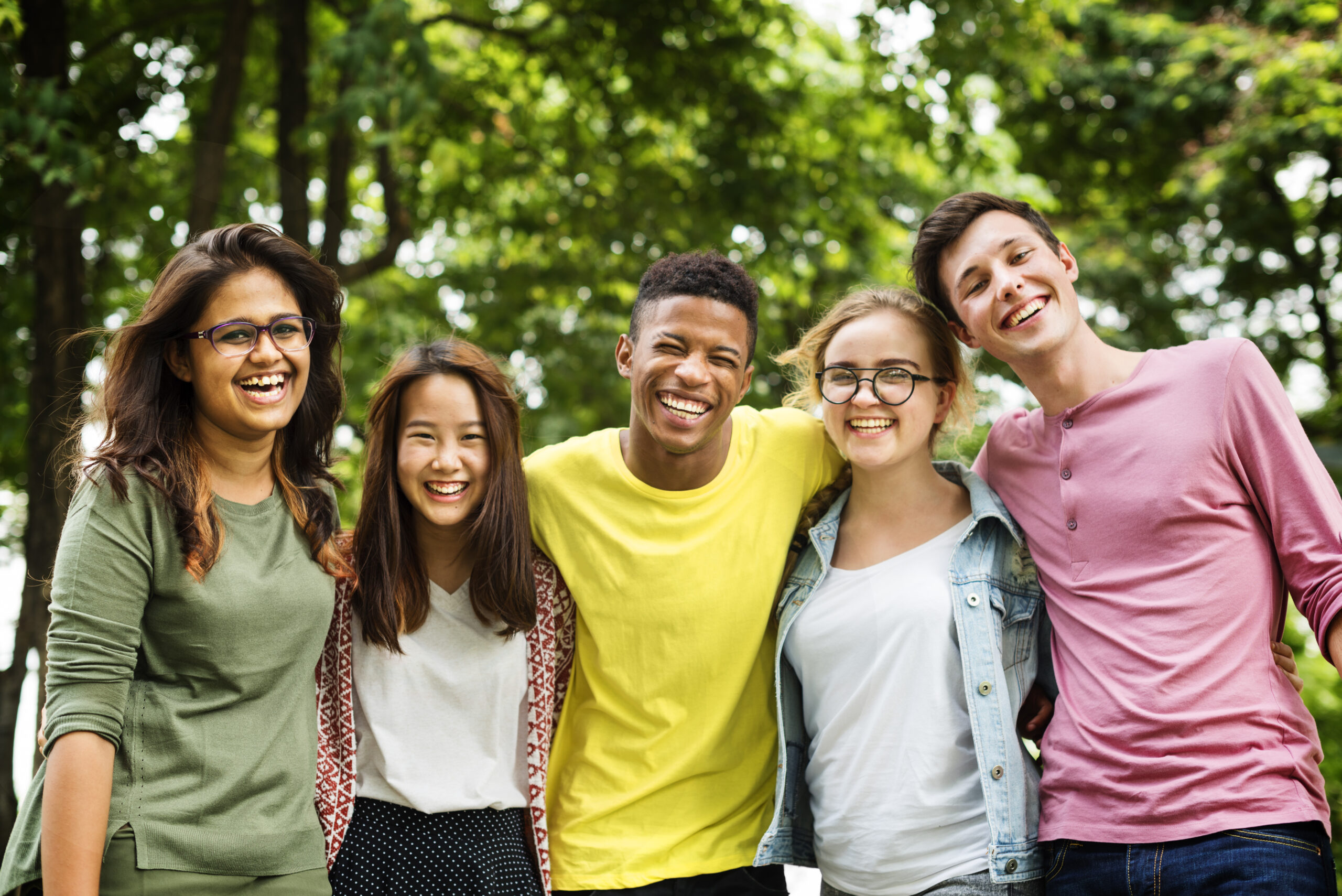 Teenagers gathering outside near trees