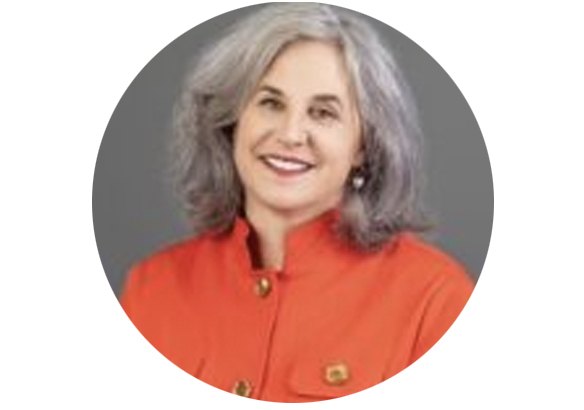 Smiling woman with gray hair wearing an orange jacket