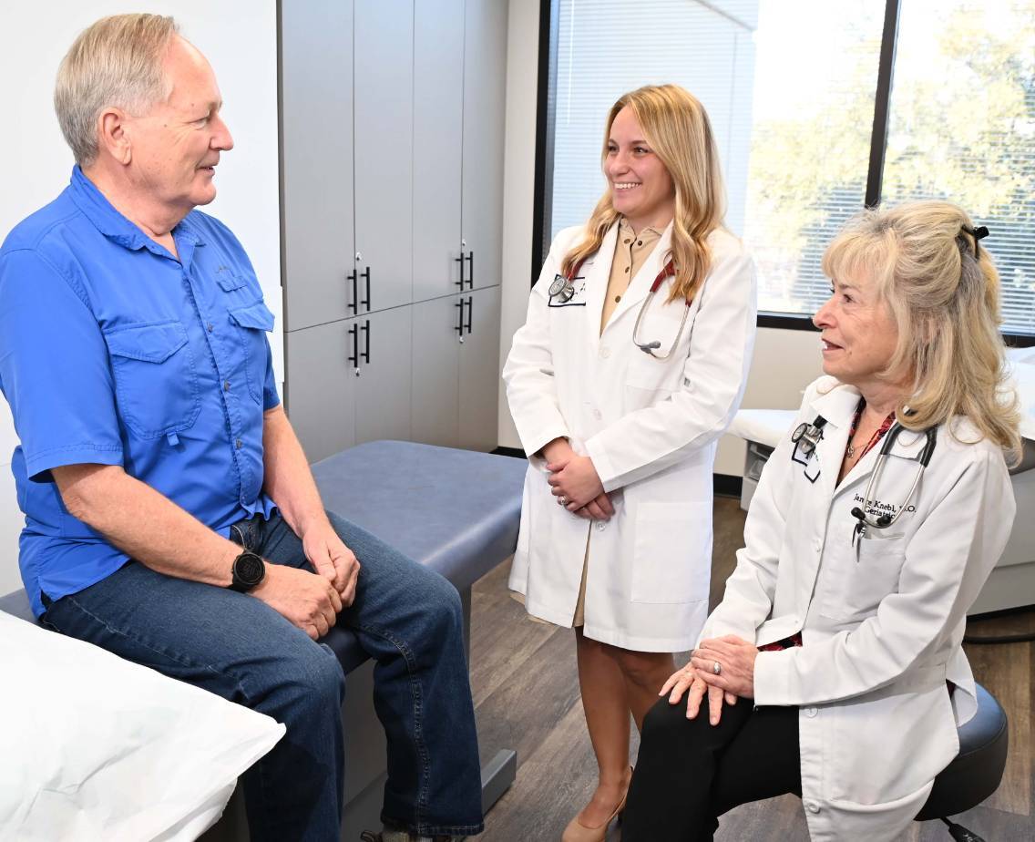 Dr. Janice Knebl and Dr. Brittany Love counseling patient