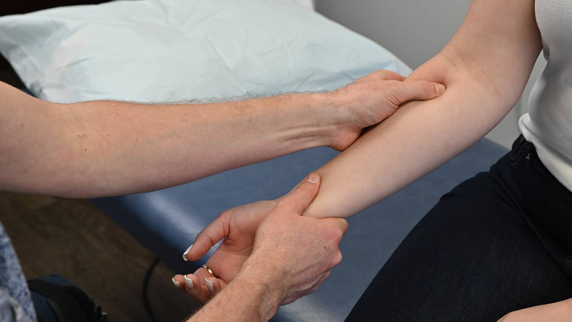 Provider checking patient's elbow
