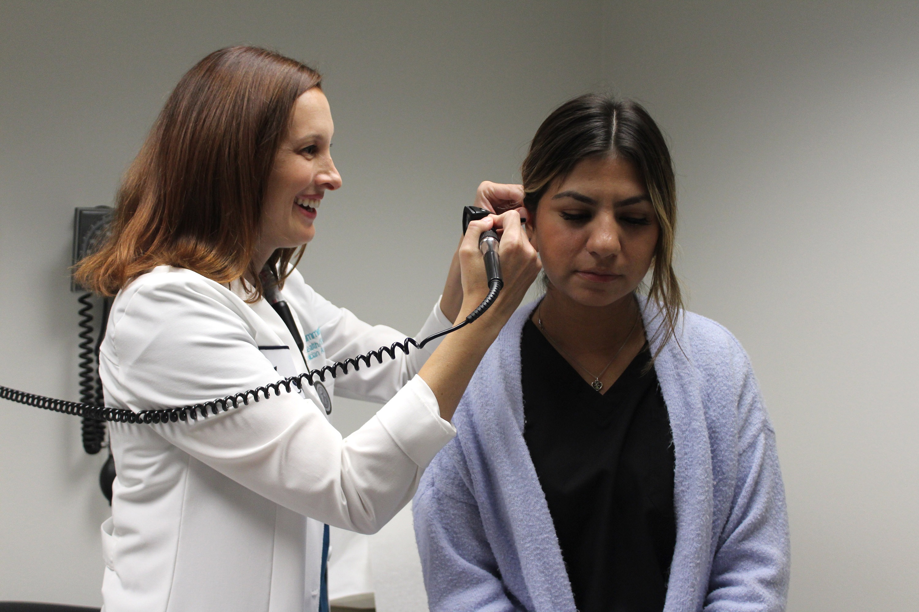 PA Monica Summerhill looking in a patient's ear