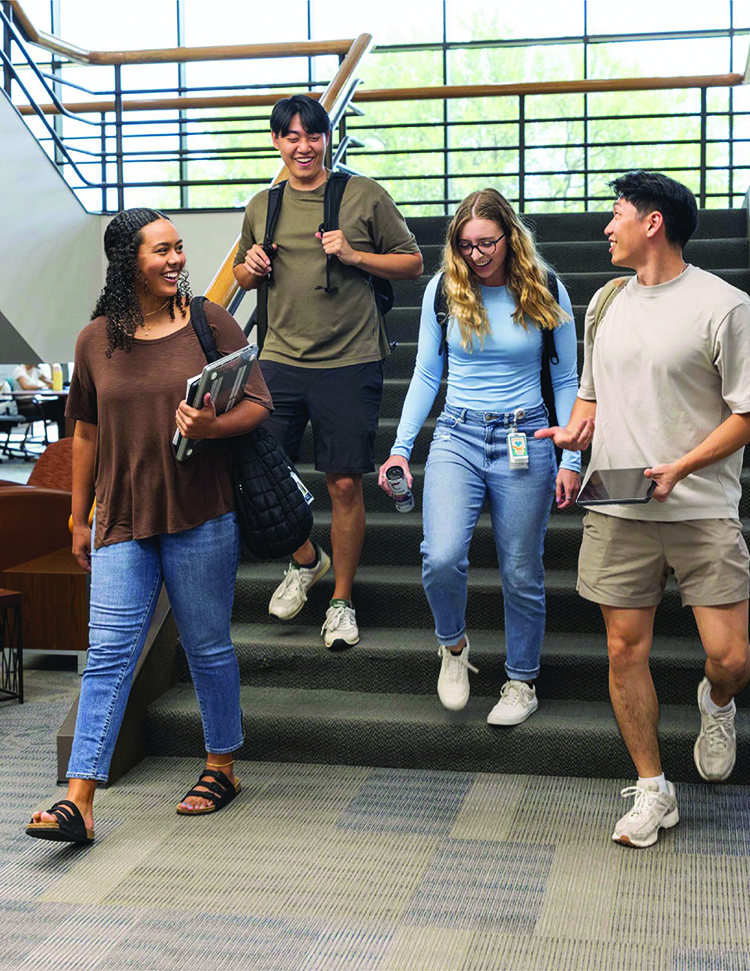 Group of students walking down the stairs talking