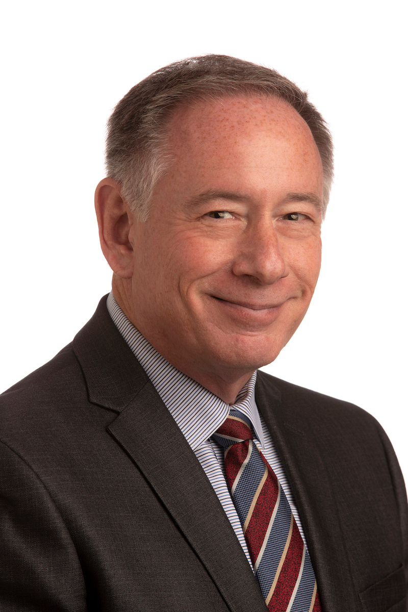 David Farmer headshot wearing a dark grey suit