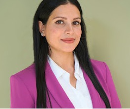 Farah Wani headshot wearing a pink blazer