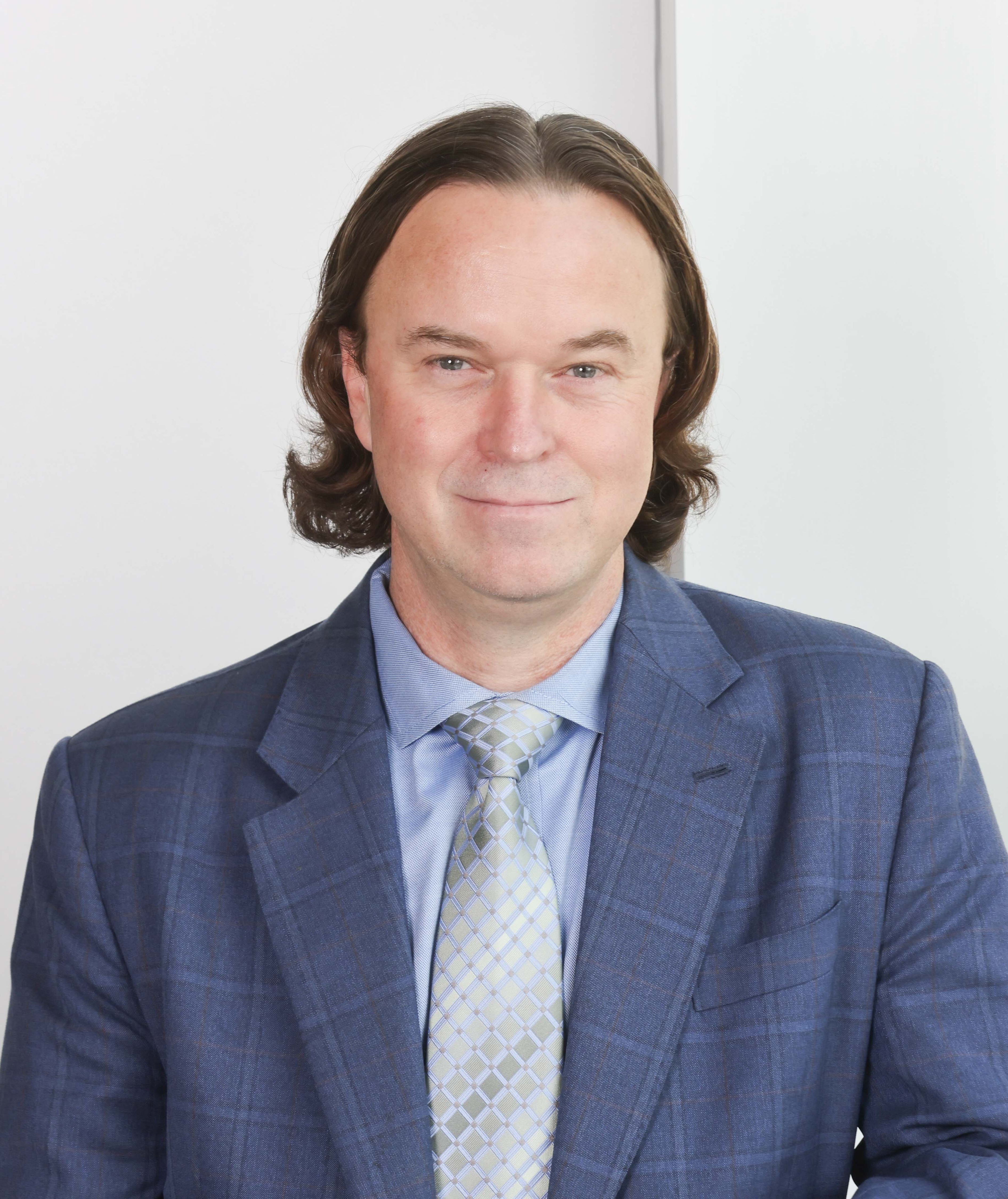 Jeff Beeson headshot wearing a blue suit