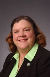Julia Reynolds headshot with a gray background