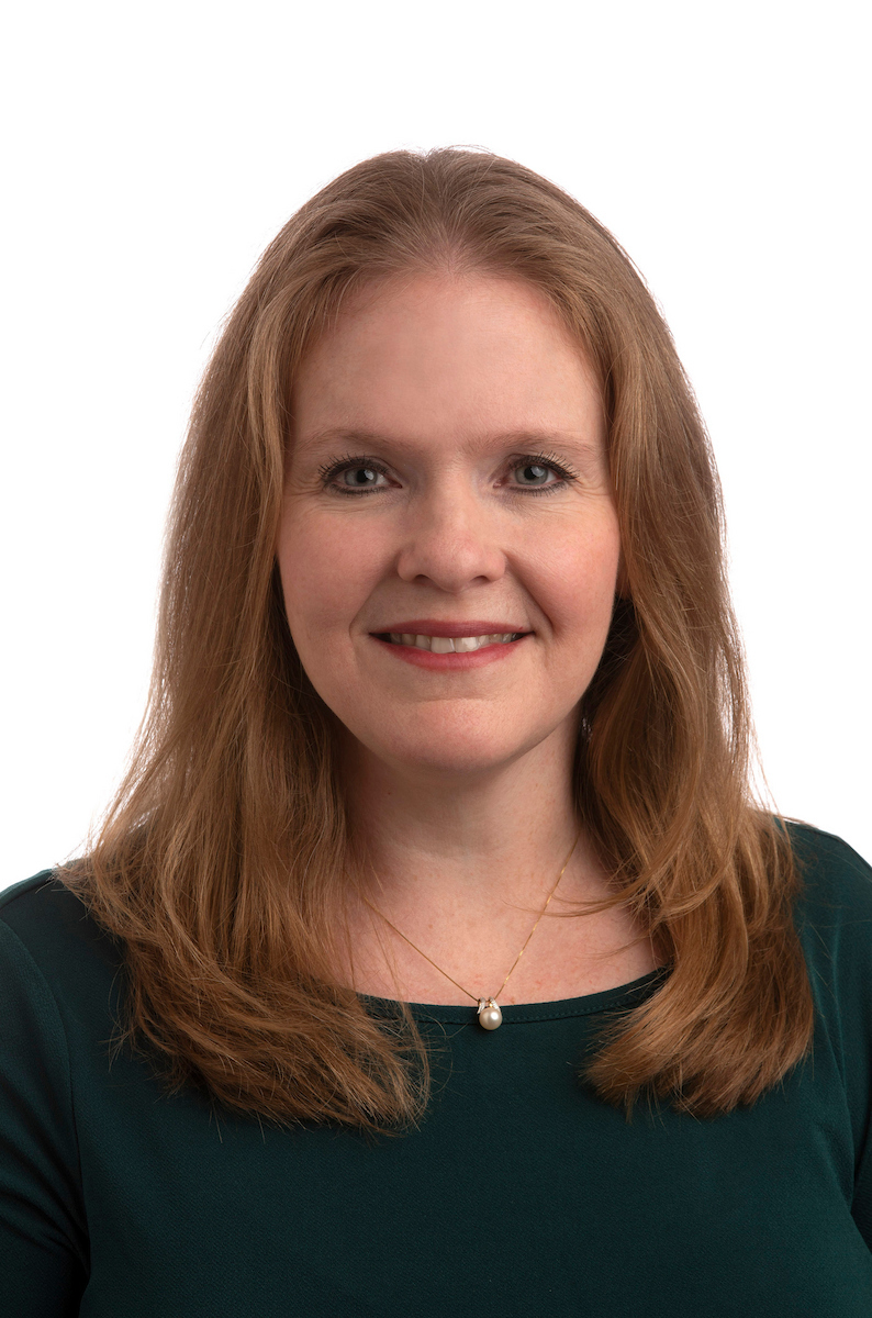 Kim Fulda headshot wearing a dark green blouse