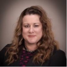 Michelle McCarroll headshot wearing a black blazer