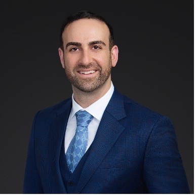 Parham Bahador headshot wearing a navy blue suit
