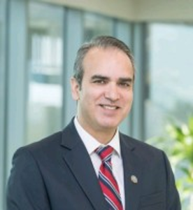 Dr. Mir headshot wearing a blue suit