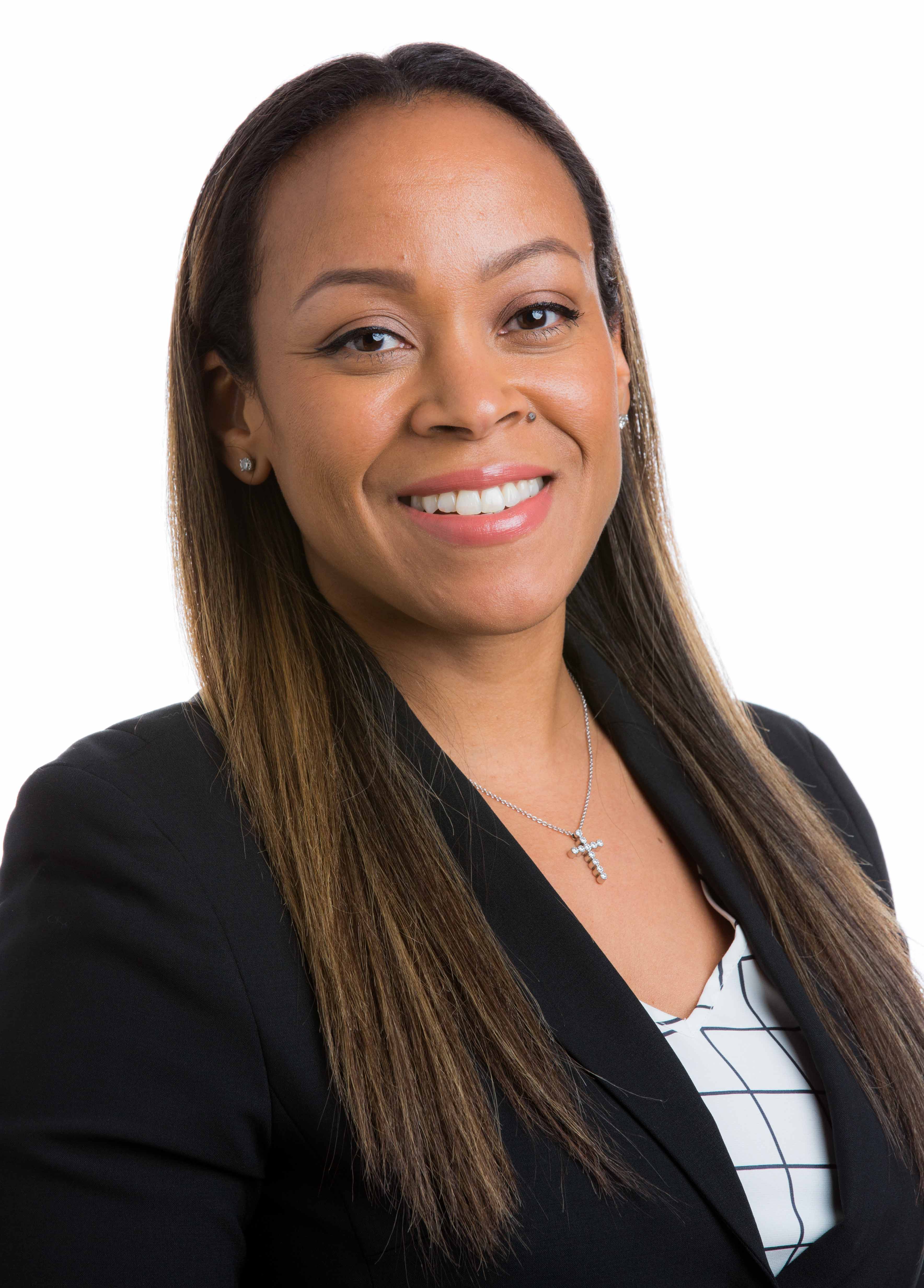 Veda Womack headshot wearing a black blazer with a white shirt underneath