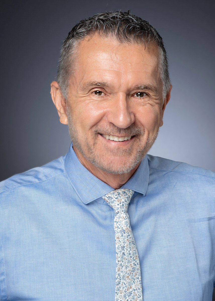 Curtis Galke headshot wearing a light blue dress shirt