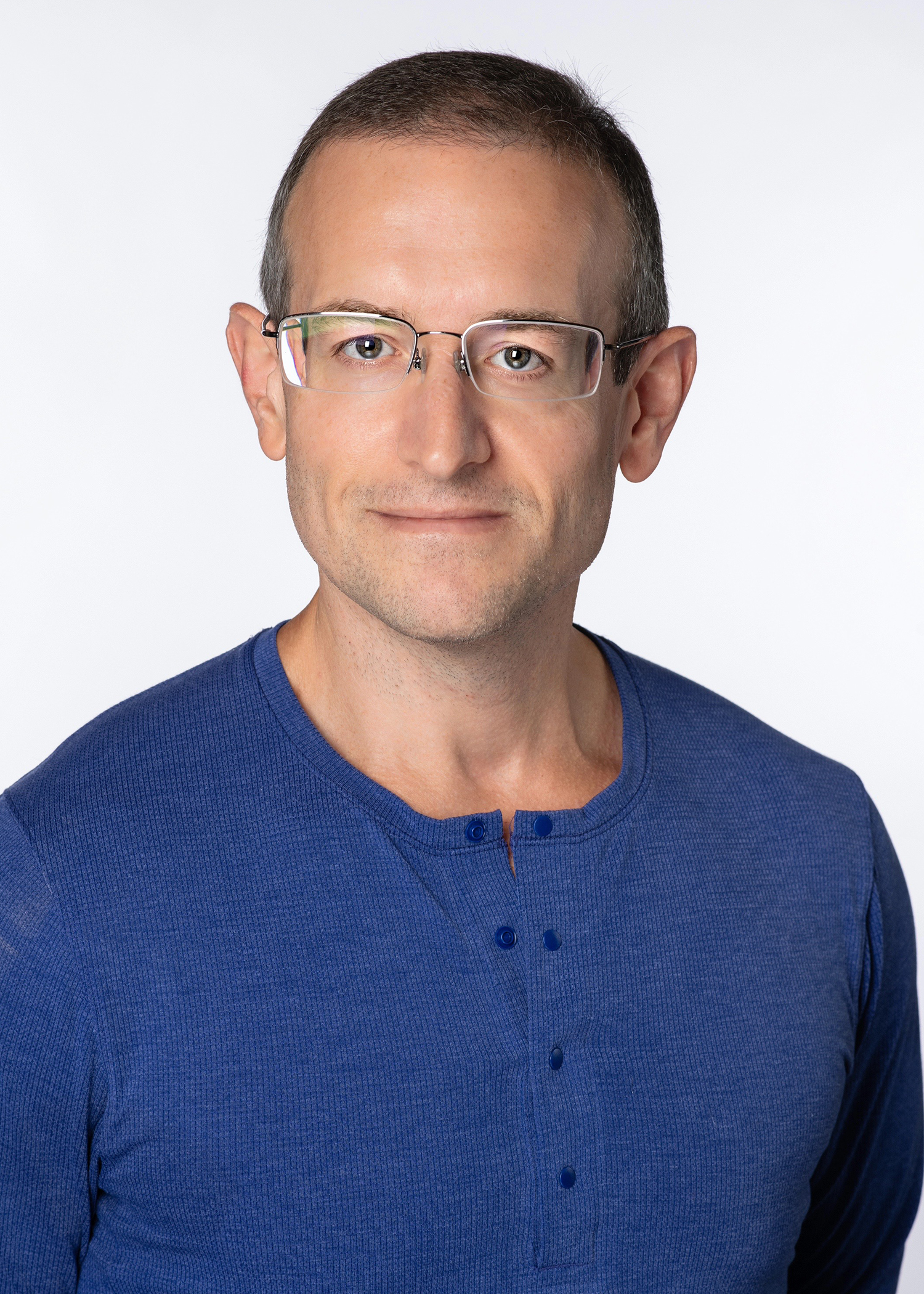 Matthew Boutte headshot wearing a blue shirt with a white background