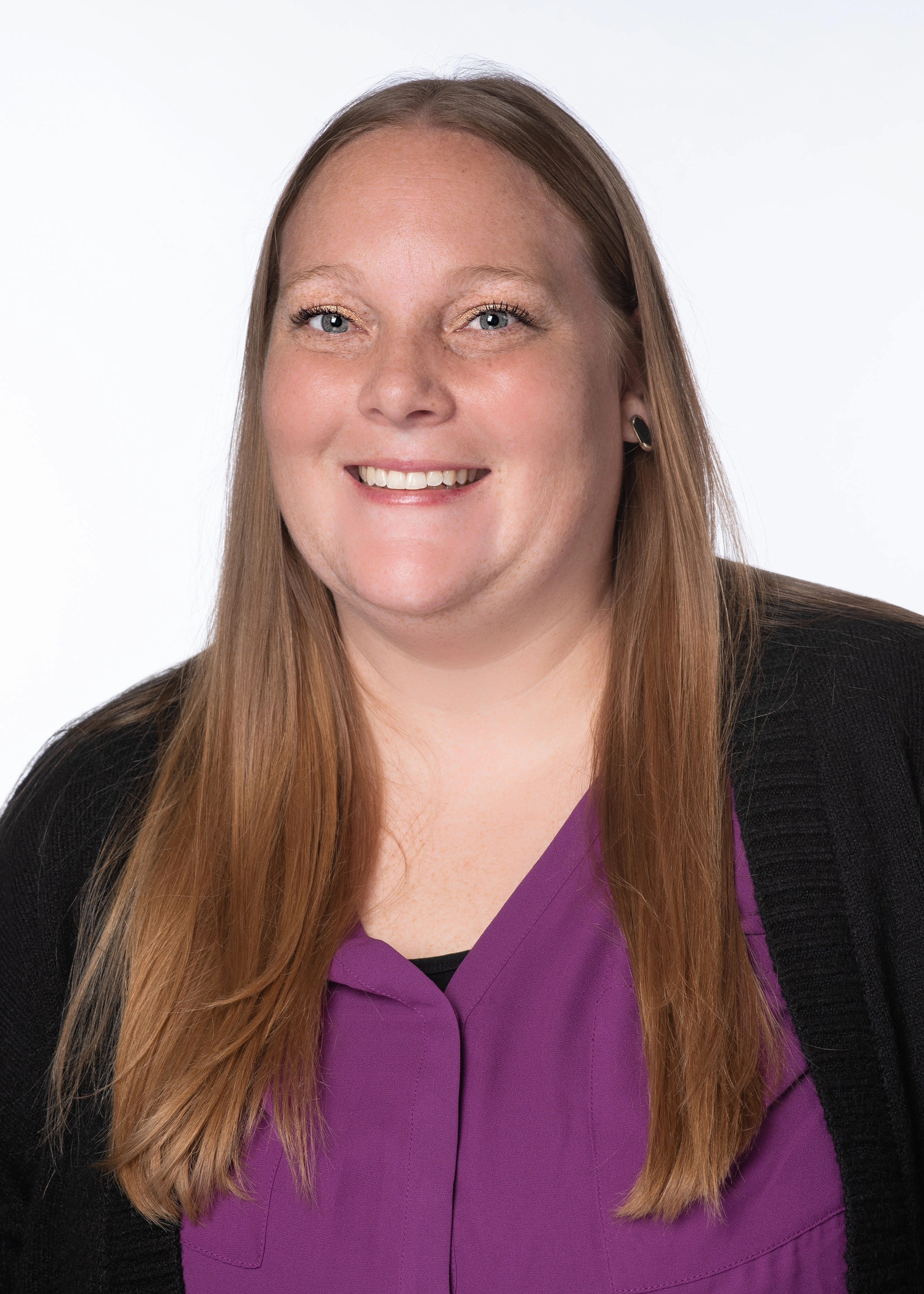 Taylor Snow headshot wearing a black jacket with a purple shirt underneath